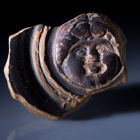 null - Black varnished guttus medallion with Gorgoneion from the Brittian necropolis of contrada Moio