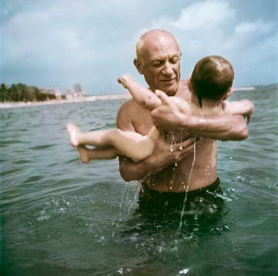 Robert Capa - Pablo Picasso playing in the water with his son Claude