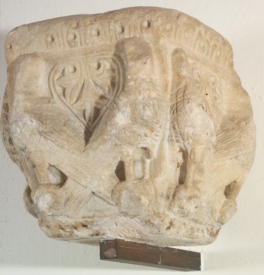 Cubic capital in decorated stone