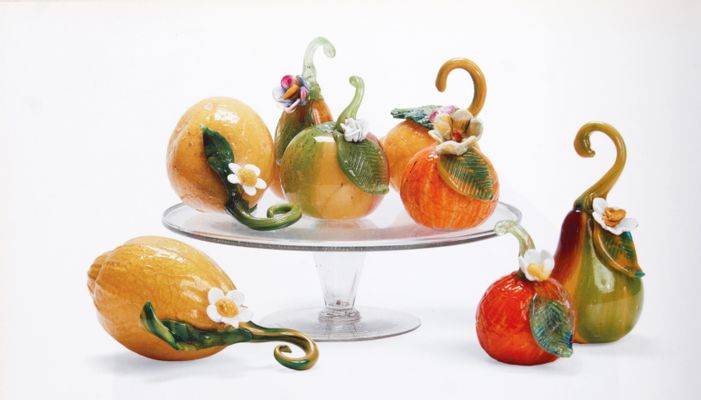 Eight glass fruits on a stand