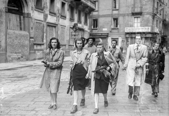 Tino Petrelli - Three girls, aggregated in groups of partisans, in Piazza Brera while they patrol the city together with the Gappisti